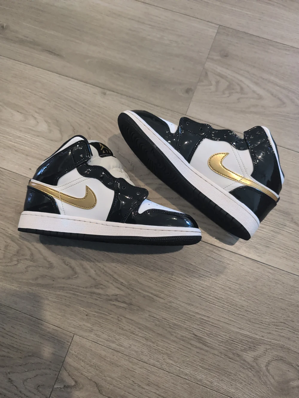 Jordan Kids High-Top Sneakers in White, Black, and Gold